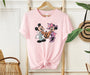 Festive Disney shirt featuring Mickey and Minnie in Halloween style.