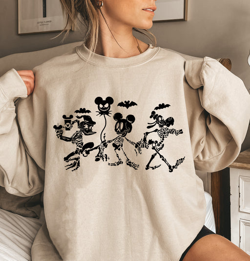 Spooky sweatshirt featuring Disney characters in skeleton designs, perfect for Halloween spirit.