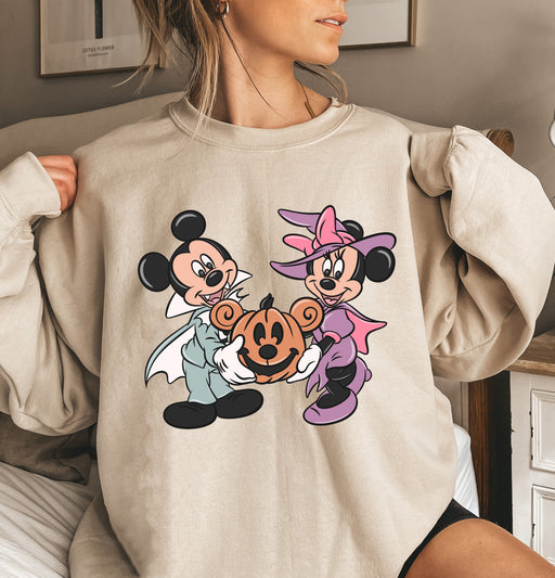 Festive sweatshirt featuring Mickey and Minnie in Halloween costumes, ideal for adding Disney magic.