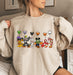 Festive sweatshirt featuring Mickey Mouse with Halloween themed balloons, ideal for spooky season.