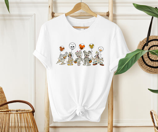 Playful Halloween shirt featuring Mickey and friends as mummies with spooky balloons.