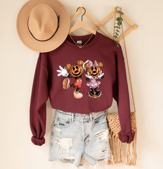 Cozy sweatshirt featuring Mickey with a pumpkin design, perfect for celebrating Halloween.